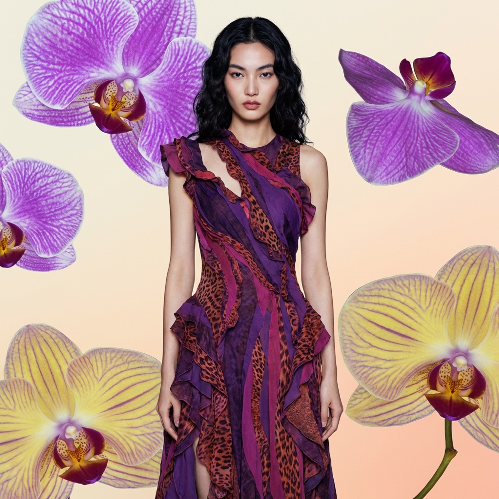Printed orchid gown, floating blooms, violet studio backdrop