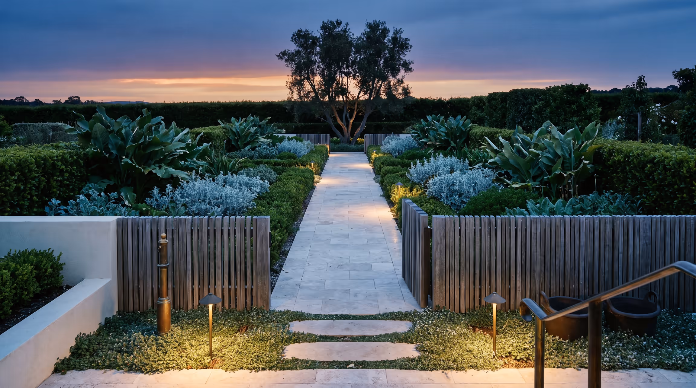 Stone steps climbing through planting at dusk