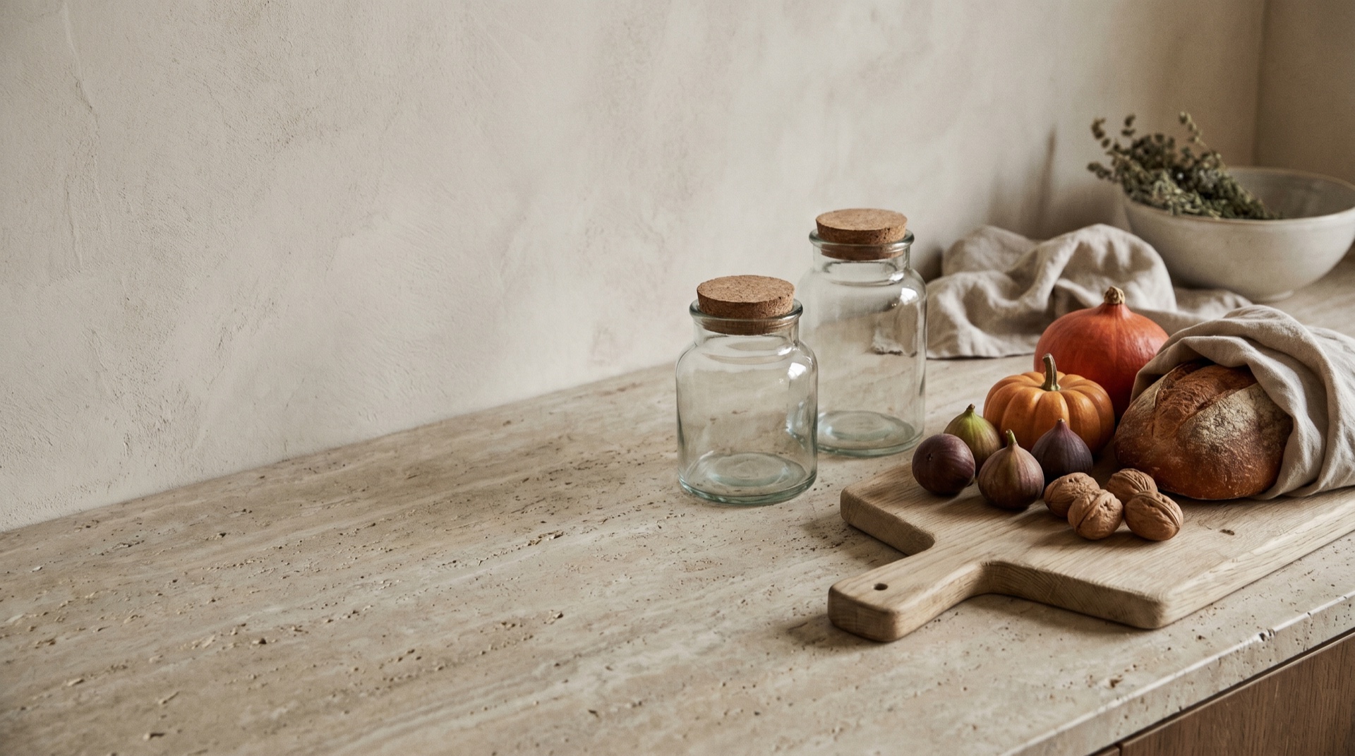 A cinematic still of artisan jars and warm produce on stone, generous negative space