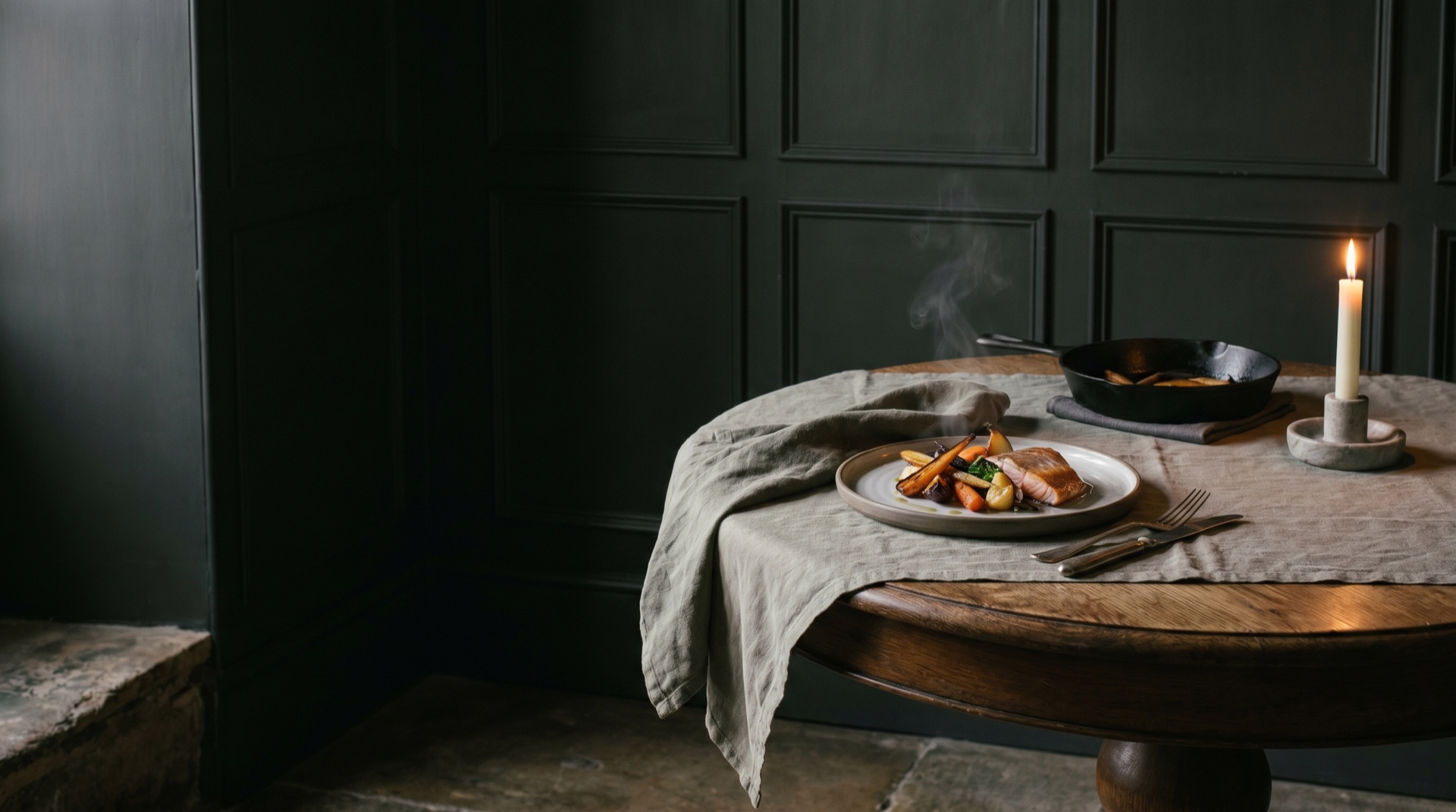 A precise, exquisitely plated fine-dining course in dark, restrained light, generous negative space